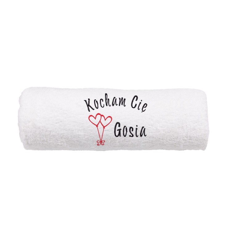 Personalizowany ręcznik frotte 500g zwinięty w estetyczny rulon, eksponujący wysoką jakość bawełny i precyzyjny haft z motywem balonów-serc