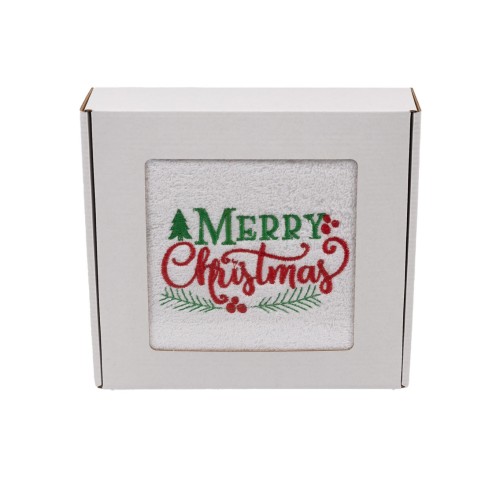 Elegancki świąteczny ręcznik frotte 500g z klasycznym haftem Merry Christmas i gałązkami ostrokrzewu, zapakowany w białe kartonowe pudełko z okienkiem, gotowy na prezent.