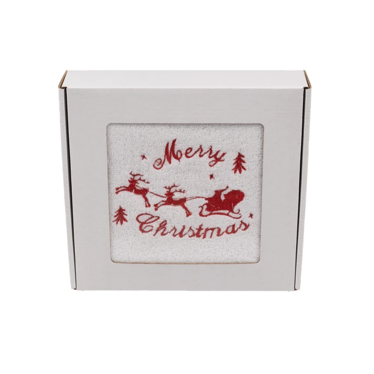 Elegancki świąteczny ręcznik frotte 500g z precyzyjnym haftem przedstawiającym sanie Mikołaja z reniferami i napis Merry Christmas, zapakowany w białe kartonowe pudełko z okienkiem, idealny na prezent.